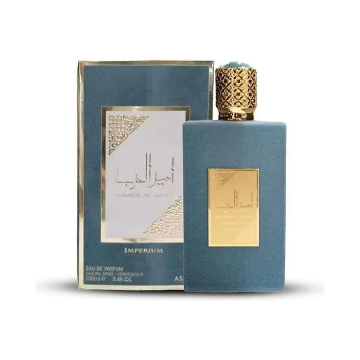 A blue Asdaf Ameer al Arab IMPERIUM Eau de Parfum for men by Royal Oud Perfumes, with a gold cap, shown beside its blue and gold box with Arabic and English text—a refined oriental fragrance.