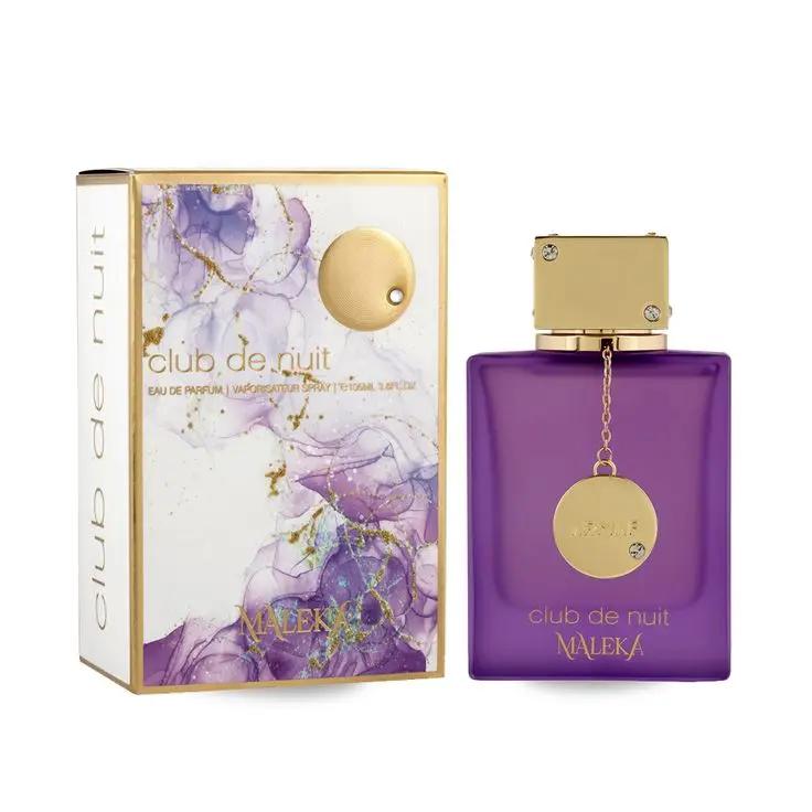 A bottle of Royal Oud Perfumes Club de nuit MALEKA, featuring a gold cap and chain, sits beside its decorative box with purple and gold marble patterns and gold text, reflecting its sofisticado aroma dulce.