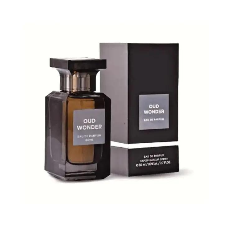 A dark glass bottle of Lattafa OUD WONDER by Royal Oud Perfumes stands beside its matching black rectangular box, both labeled and displayed on a white background.