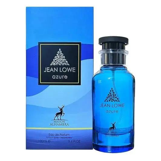 A blue bottle of Maison Alhambra JEAN LOWE AZURE by Royal Oud Perfumes stands beside its matching blue and black box, both adorned with a silver tree logo and showcasing an elegant, minimalist design.